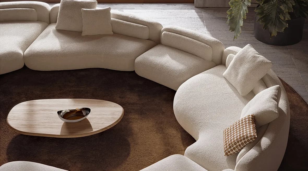 Circular cream bouclé sofa with organic shapes and plush cushions