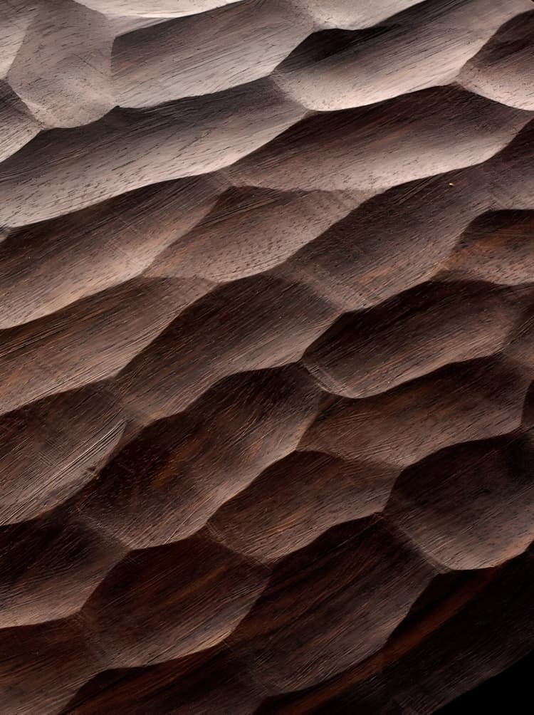 Carved wood texture with organic, faceted surface patterns