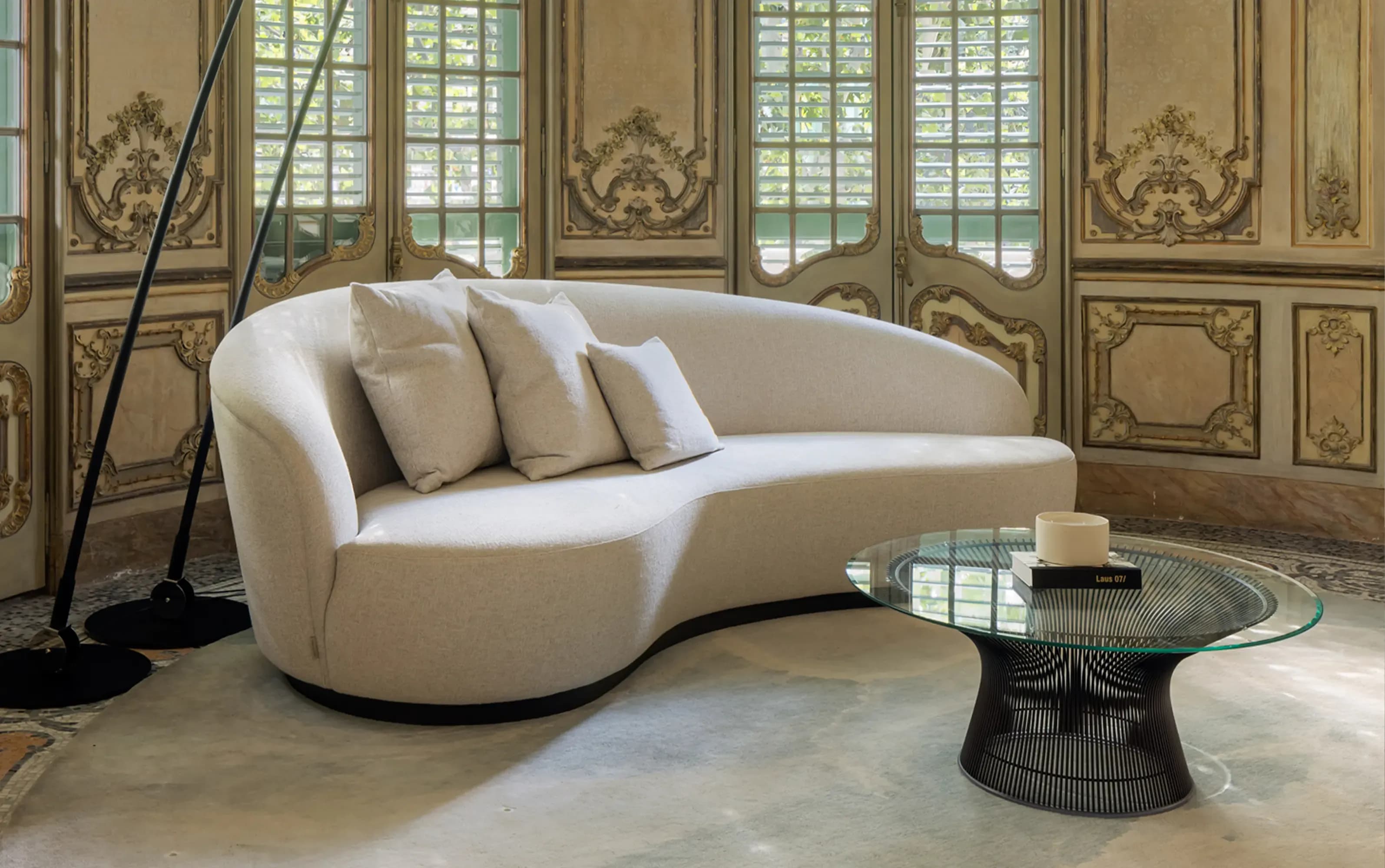 Curved beige sofa in a refined interior with decorative details · LUV Lifestyle FF&E