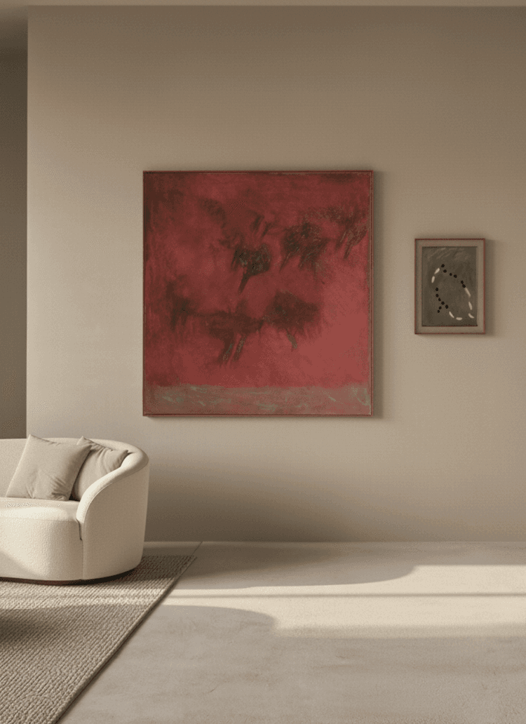 Modern living room with cream armchair, large red abstract painting, and soft natural light on neutral walls.