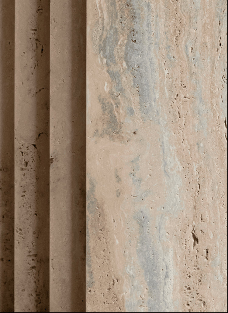 Close-up of natural travertine stone surface with vertical fluted texture and subtle beige and grey tones.