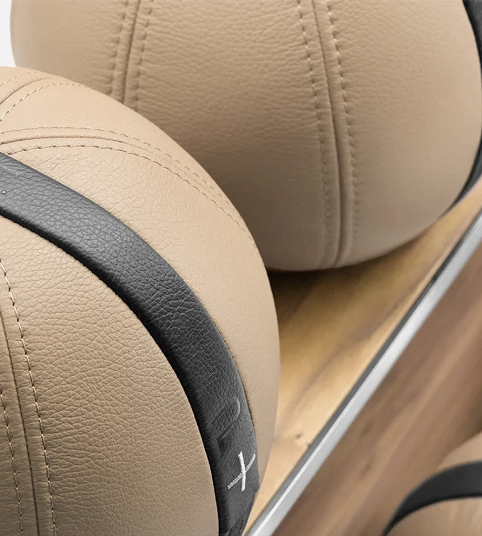 Leather medicine balls with contrast stitching on a wooden rack